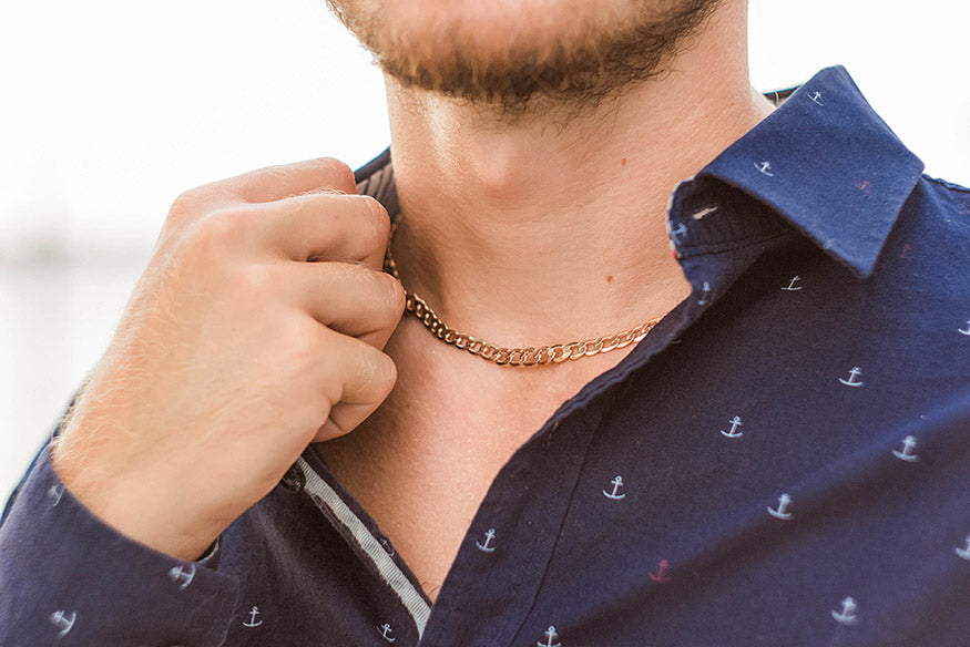 golden pendant on the neck of a man